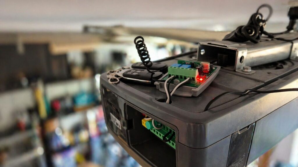 Garage door motor with smart receiver and remotes during programming on the Gold Coast