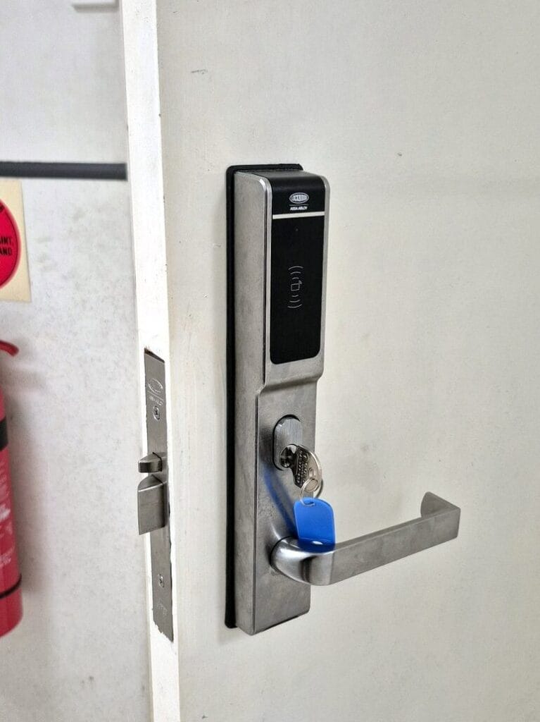 Commercial door fitted with an electronic card access lock and lever handle